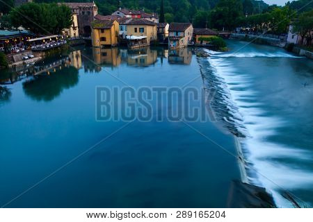 Panoramic night view of Borghetto (Valeggio sul Mincio, Verona) from the bridge on the river Mincio