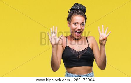 Young braided hair african american with pigmentation blemish birth mark over isolated background showing and pointing up with fingers number nine while smiling confident and happy.