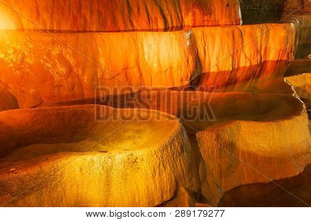 Cave Lake Nature Background. Amazing Cave Lake Nature Background. Artificial Orange Lights In Cave. 