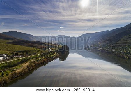 Aerial View Of The Terraced Vineyards In The Douro Valley And River Near The Village Of Pinhao, Port