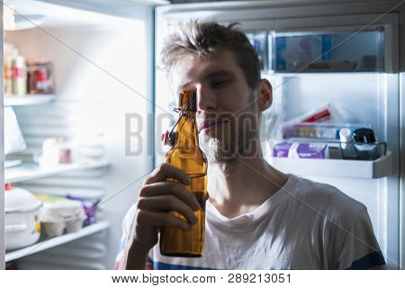 Man Drink Bear From Refridgerator At Night Time