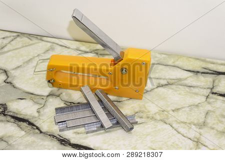 Large Stapler And Staples For Construction Work On White