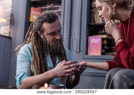 Positive Bearded Man Working As A Chiromancer