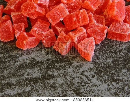 A Bunch Of Red Candied Fruits. Background Gray Loft.