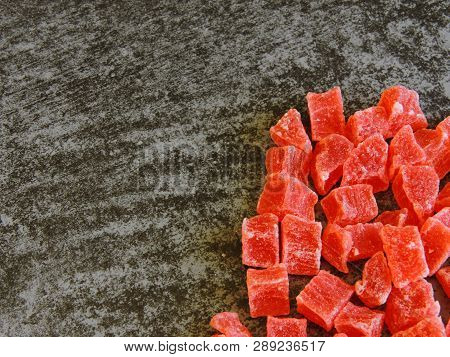 A Bunch Of Red Candied Fruits. Background Gray Loft.