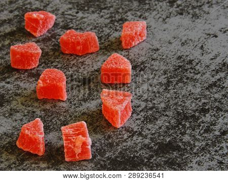 A Bunch Of Red Candied Fruits. Background Gray Loft.
