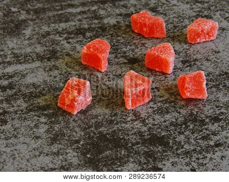 A Bunch Of Red Candied Fruits. Background Gray Loft.