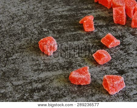 A Bunch Of Red Candied Fruits. Background Gray Loft.