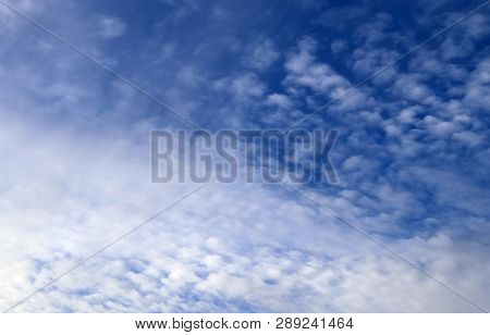 Beautiful Alto Cumulus Cloud Formations On A Deep Blue Sky