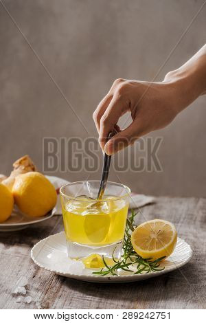 Ginger Tea With Lemon, Ginger Root And Rosemarry On Wooden Background. Small Glass Transparent Pitch