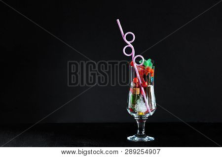 Coctail Glass With Plastic Straw Full Of Plastic And Battery Waste As Imitation Of Real Drink On Hor