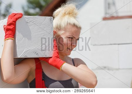 Strong Pretty Woman Working On Construction Site, Building House, Installing Gray Airbricks. Industr
