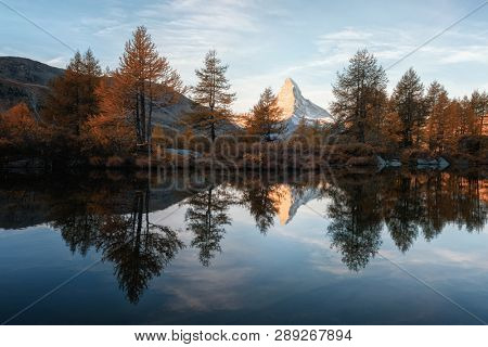Incredible colorful sunset on Grindjisee lake with Matterhorn Cervino peak in Swiss Alps. Zermatt resort location, Switzerland. Landscape photography