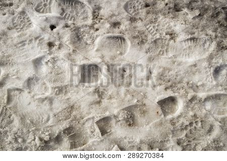 Footprints In The Snow. Snowbreak, Thaw. Spring. Snow Background. Slush. Snow Texture