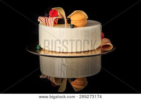 Delicious Round Cake With White Glaze And Ellow Macaron
