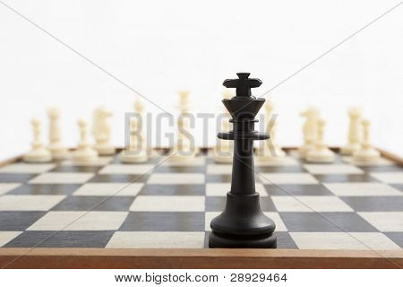 Fallen king pieces surrounded by the other color chess pieces