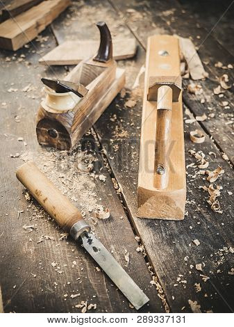 Old Woodworking Hand Tool: Wooden Plane, Chisel And In A Carpentry Workshop On Dirty Rustic Table Co