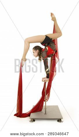 Flexible Equilibrist Performs Exercises On Acrobatic Walking Sticks. Studio Photo On White Backgroun