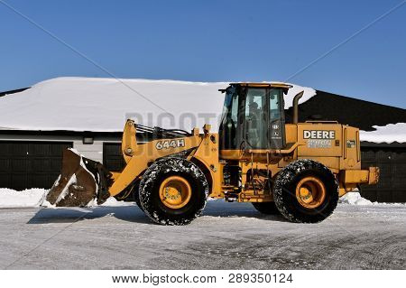 Fargo, North Dakota, March 11, 2019: A Huge 4-wheel Drive Tractor(644h) With A Massive Bucket For Sn