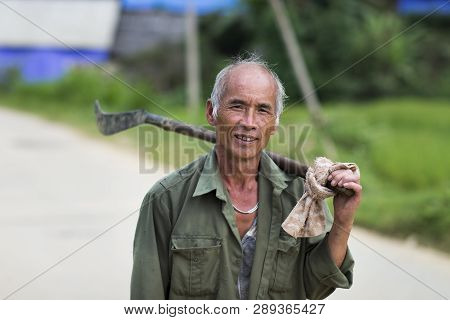 Sapa, Lao Cai, Vietnam - 08 16 2014: Portrait Of A Vietnamese Farmer Walking On A Road In Sapa, Lao 