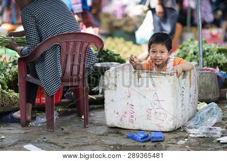 Bac Ha, Lao Cai, Vietnam - 08 17 2014: A Vietnamese Kid Playing In A Polystyrene Box In Bac Ha Marke