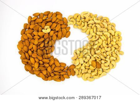 Cashew And Almond Nut Yin Yang Sign On White Background. Scattered Nut On Table. Organic Food Rustic