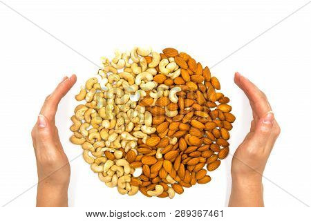 Almond And Cashew Nut With Woman Hands On White Background. Nut Ornament In Palms. Tasty Healthy Sna