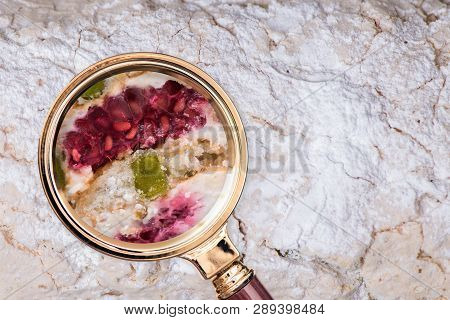 Cake In The Magnifying Glass. Food Composition Analysis Concept.