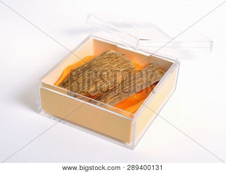 Agarwood, Also Called Aloeswood Oudh. In The Plastic Box On White Background