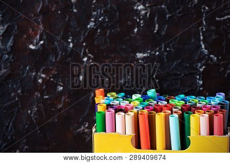 A Set Of Colorful Markers, With A Place For Copy Space On Black Background