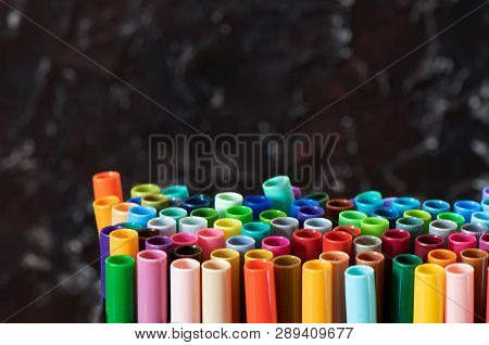 A Set Of Colorful Markers, With A Place For Copy Space On Black Background