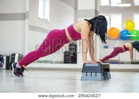 Adult Girl Engaged In Fitness In The Gym. The Concept Of Sports, A Healthy Lifestyle, Losing Weight.