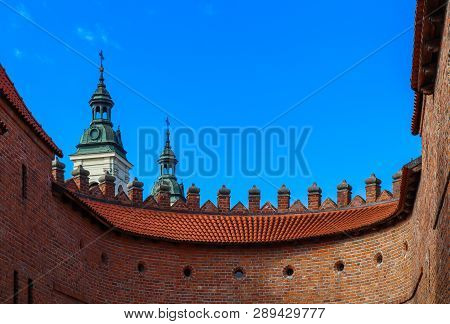 Two Towers With Spiers And Red Brick Walls Of Warsaw Barbican, Poland