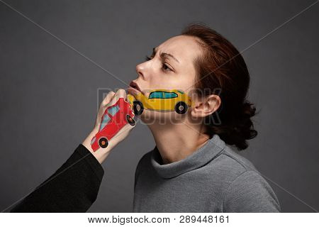 The Concept Of Auto Accident And Insured Event. Painted Machine On The Girl's Face Faced With A Pain