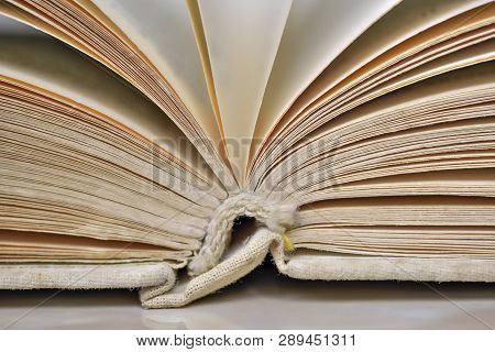 Opened Old Book In A Bright Cover Lies On The Table Close-up Design Blank For The Project