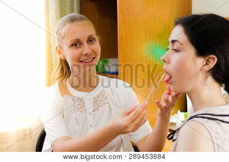 The Speech Therapist Works With The Patient Over The Speech, Showing The Logopedic Probe The Positio