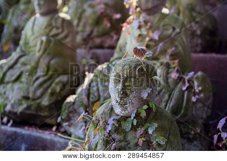Stone Statue Of A Seated Japanes Buddhist Monk Close-up