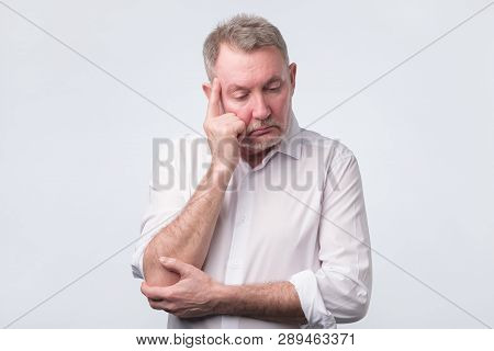 Sad Senior Man In White Shirt Thinking Abour Life.