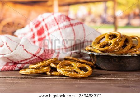Lot Of Whole Mini Salted Pretzels In Old Iron Bowl In A Yard