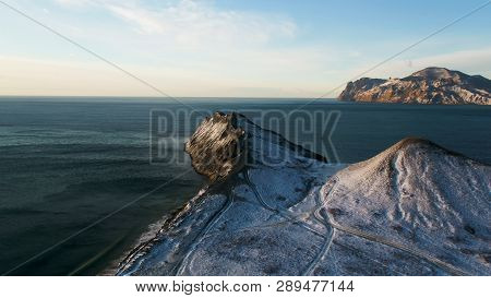 Aerial View On The Edge Of The Mountain Coast In Greenland. Aerial View On Snow Covered Mountains In