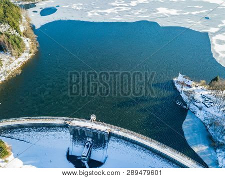 Aerial View Of The Partially Frozen Brucher Dam (bruchertalsperre) Near Marienheide In Winter.