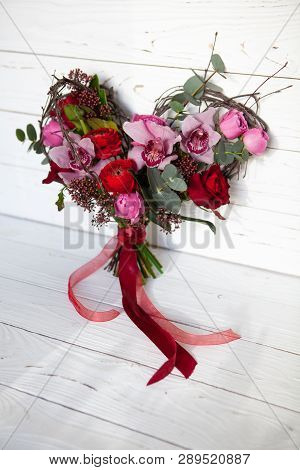 Unusual Creative Bouquet Of Flowers In Shape Of Heart On White Wooden Background. February 14 Card F