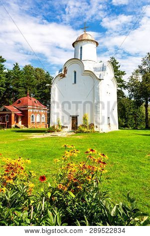 Historic Church Of The Nativity Of The Theotokos (1226) With Colorful Flowers On Foregroundon On Per