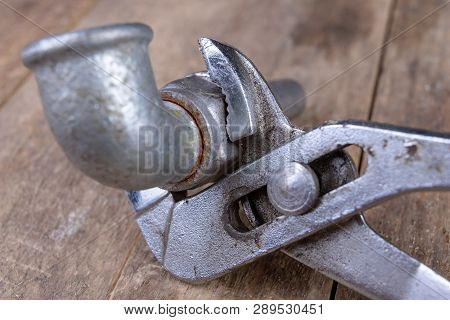 Hydraulic Wrench And Steel Pipes On A Workshop Table. Minor Mechanical Work.