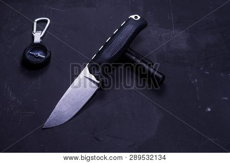 Knife with fixed blade. Isolate a knife on a black background. Knife and compass.
