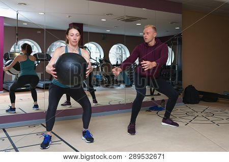 Fitness Parners In Sportswear Doing Exercises At Gym. Fitness Sport Gym Concept