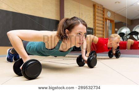Fitness Parners In Sportswear Doing Exercises At Gym. Fitness Sport Gym Concept
