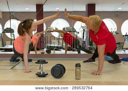 Fitness Parners In Sportswear Doing Exercises At Gym. Fitness Sport Gym Concept