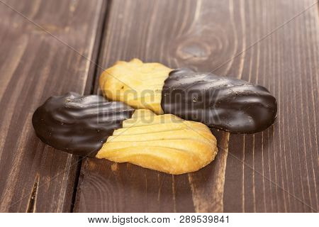 Group Of Two Whole Lazy Cookie With Chocolate On Brown Wood