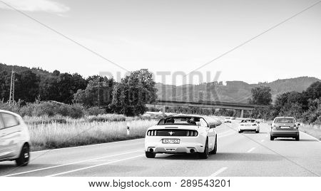 Schiltach, Germany - Jun 10, 2018: Black And White Image Of German Highway With Luxury Mustang Conve